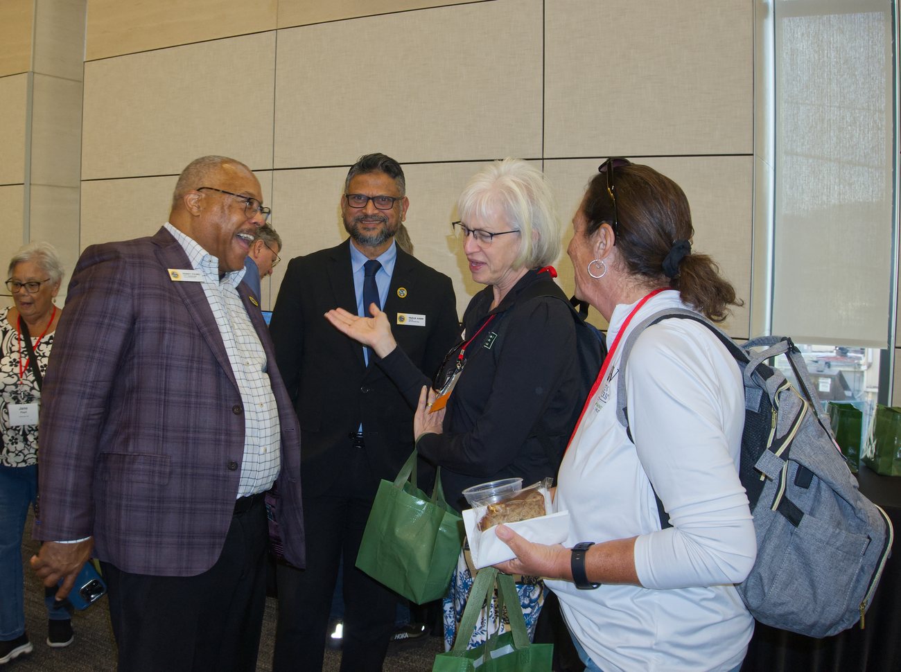 Event guests and officials sharing a laugh at College Park City Hall